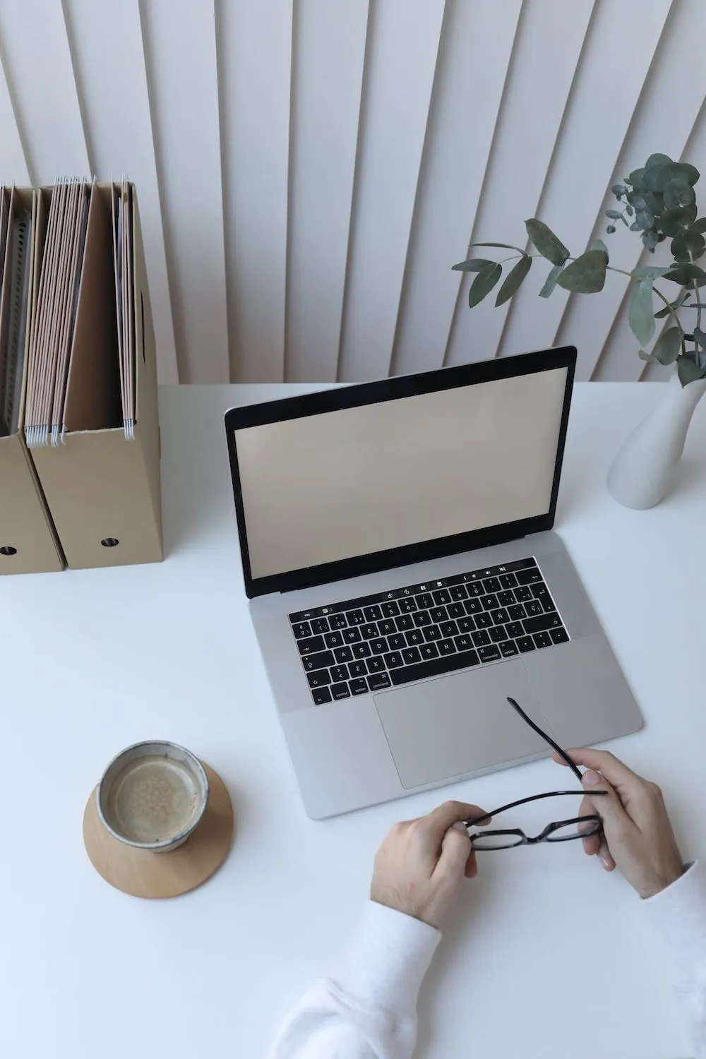 hands on desk holding glasses